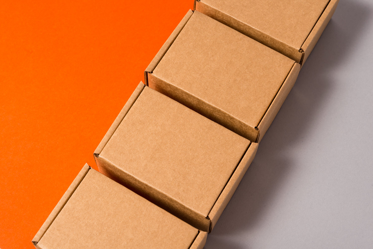 A row of shipping boxes for subscription orders, which can be efficiently packed and shipped by pre-manifesting on a multi-carrier shipping system.
